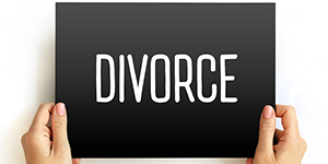 person holding a sign that says Divorce